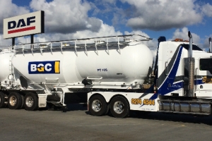 heavy tow truck transporting BCG tankers