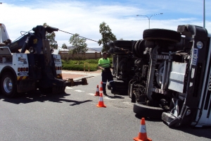 heavy tow truck with crane recovering a truck