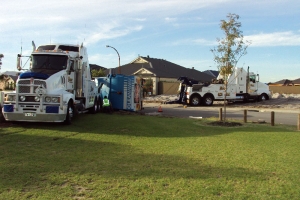 two trucks recovering a rolled truck