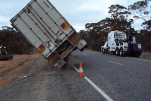 tow truck recovering rolled truck