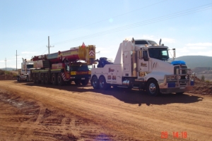 heavy tow truck transporting a crane