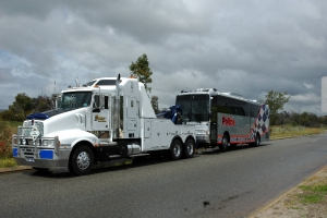 heavy tow truck transporting a police bus