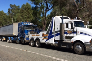 heaving tow truck flat towing a large truck