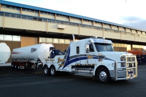 tow truck transporting a tanker