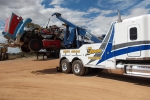 freightliner Coronado loading recovered equipment onto tow truck