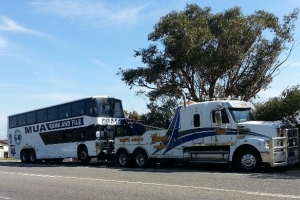 heavy tow truck toing a bus
