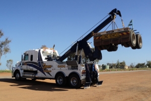 two truck with crane recovering part of a truck